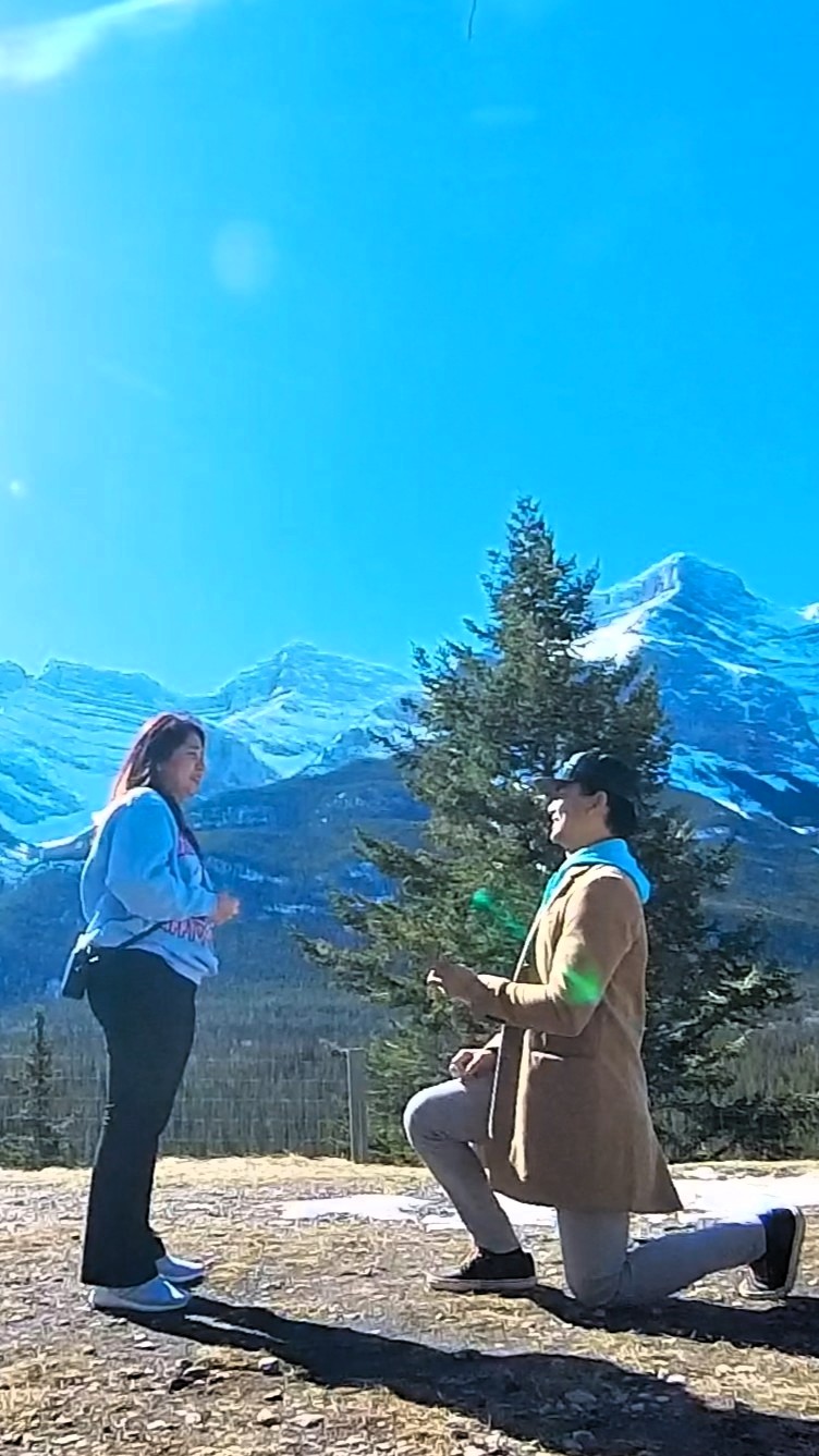 Mark proposing to Danica in the mountains near Canmore.